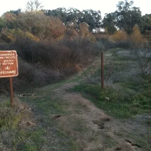 entrance of short trail to river's edge and a small sandy beach