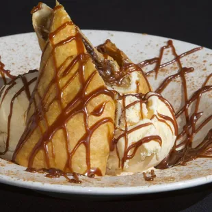 a dessert with ice cream and caramel