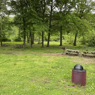 Outdoor picnic tables next to fishing lake