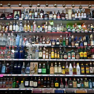 a shelf full of liquor bottles