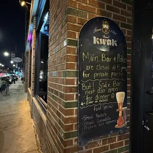 a menu on a brick wall