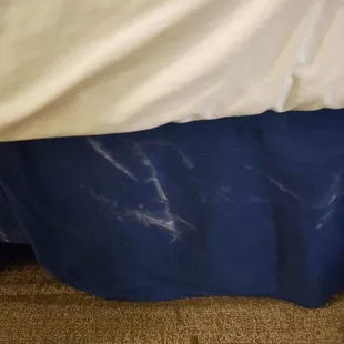 Something all over bed skirt. Bodily fluids?