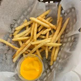 a basket of french fries with mustard
