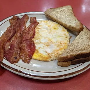 a plate of bacon, eggs and toast