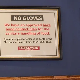 two framed signs on a blue wall