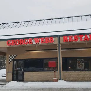 the front of a restaurant in the snow