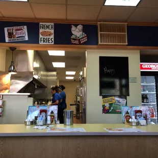 a man standing at a counter in a restaurant