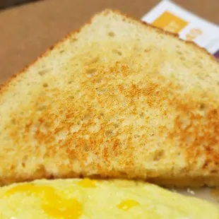 a toasted egg and toast on a plate