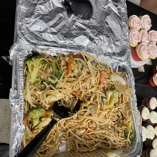 a tray of noodles and cupcakes