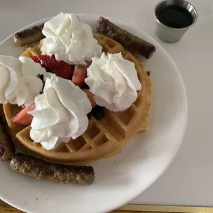 Waffle with strawberries and blueberries with side of sausage links.. oh and sugar free syrup too