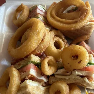 Club sandwich with onion rings.
