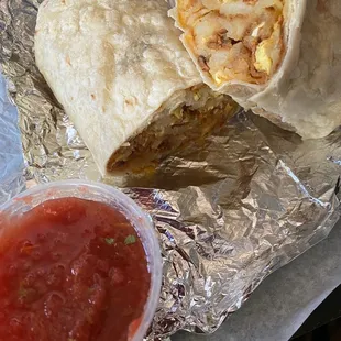 Breakfast burrito - bacon, homestyle potatoes, cheese, and eggs with a side of salsa