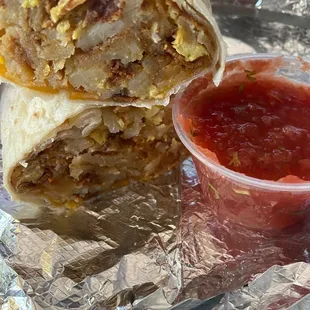 Breakfast burrito - bacon, homestyle potatoes, cheese, and eggs with a side of salsa