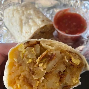 Breakfast burrito - bacon, homestyle potatoes, cheese, and eggs with a side of salsa