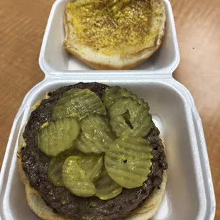 Double meat cheeseburger with mustard, pickles, and jalapeños - Delicious