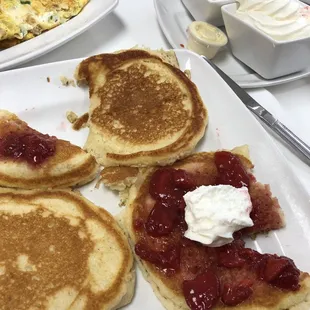 Pancakes with side of strawberries and whip cream
