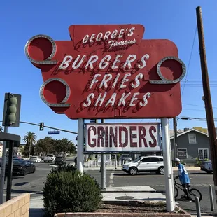 a sign for burgers fries shakes grinders