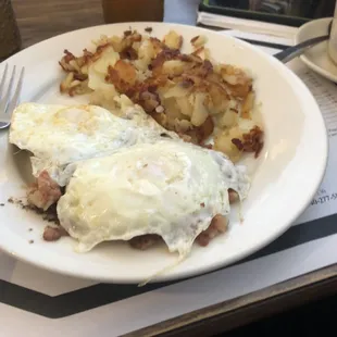 Corn beef hash with over easy egg and side of hash brown.