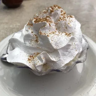 a dessert with whipped cream and cinnamon sprinkles