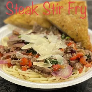 a plate of spaghetti with meat and vegetables