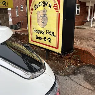 a sign for george's happy hog barbeque