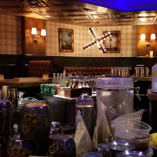 a bar with a lot of bottles and glasses