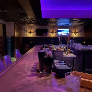 a bar with purple lighting