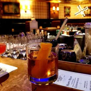 a drink in a glass on a bar