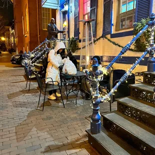  man sitting at a table outside a restaurant