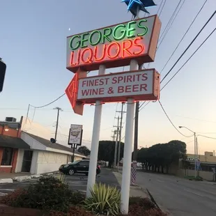 a neon sign for george's liquors