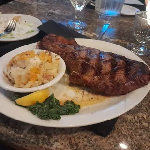 23 Oz. Bone-in Ribeye with loaded baked potato casserole.