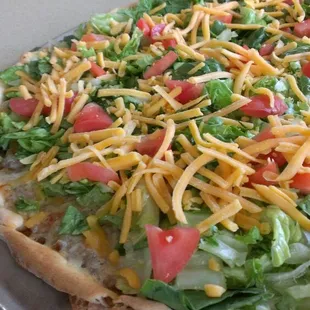 a pizza with cheese and lettuce