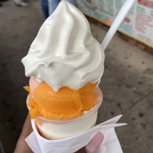 a hand holding an ice cream cone