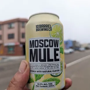 a hand holding a can of moscon mile