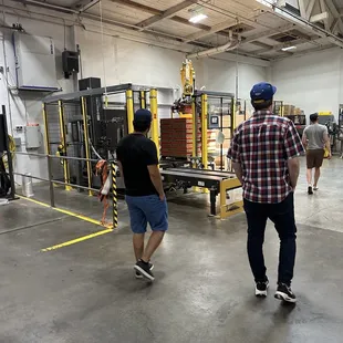 two men walking in a warehouse