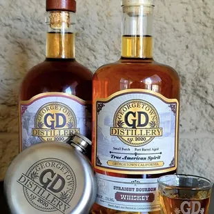 two bottles of bourbon and a shot glass