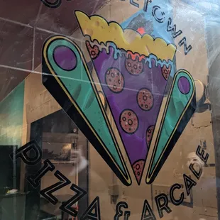 a slice of pizza in the window