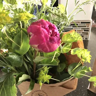a hand holding a bouquet of flowers