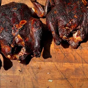 two roasting chickens on a cutting board