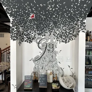 black and white mural of a woman under a tree