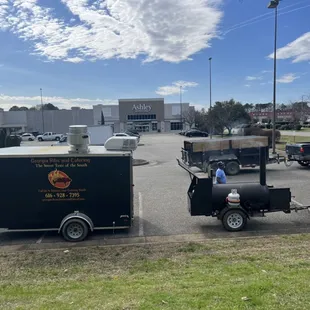 a bbq trailer with a bbq trailer attached to it