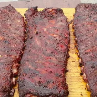 three ribs on a cutting board