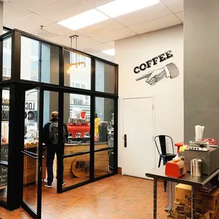 Clean open lobby space with table for all your coffee fixin's.