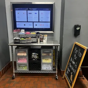 a counter with a tv and a chalk board