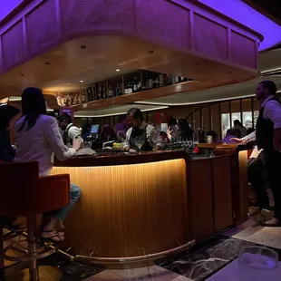 a group of people sitting at a bar