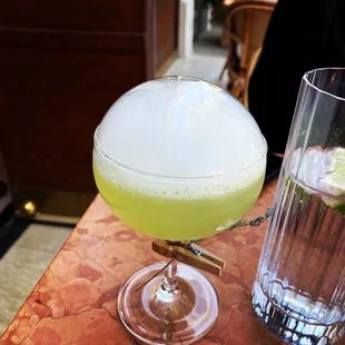 a margarita and a glass of water on a table