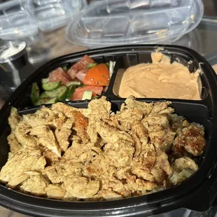 Chicken Shawarma plate with Hummus and Mediterranean Salad  and garlic spread is the