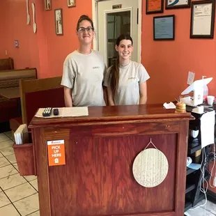 two people behind the counter