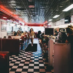 diners in a diner with checkered floor