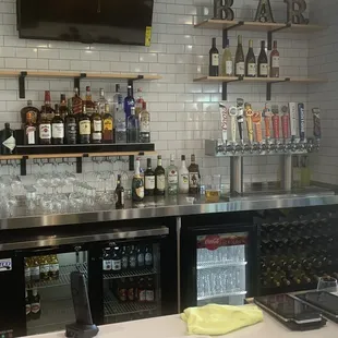 a bar with a lot of bottles of alcohol